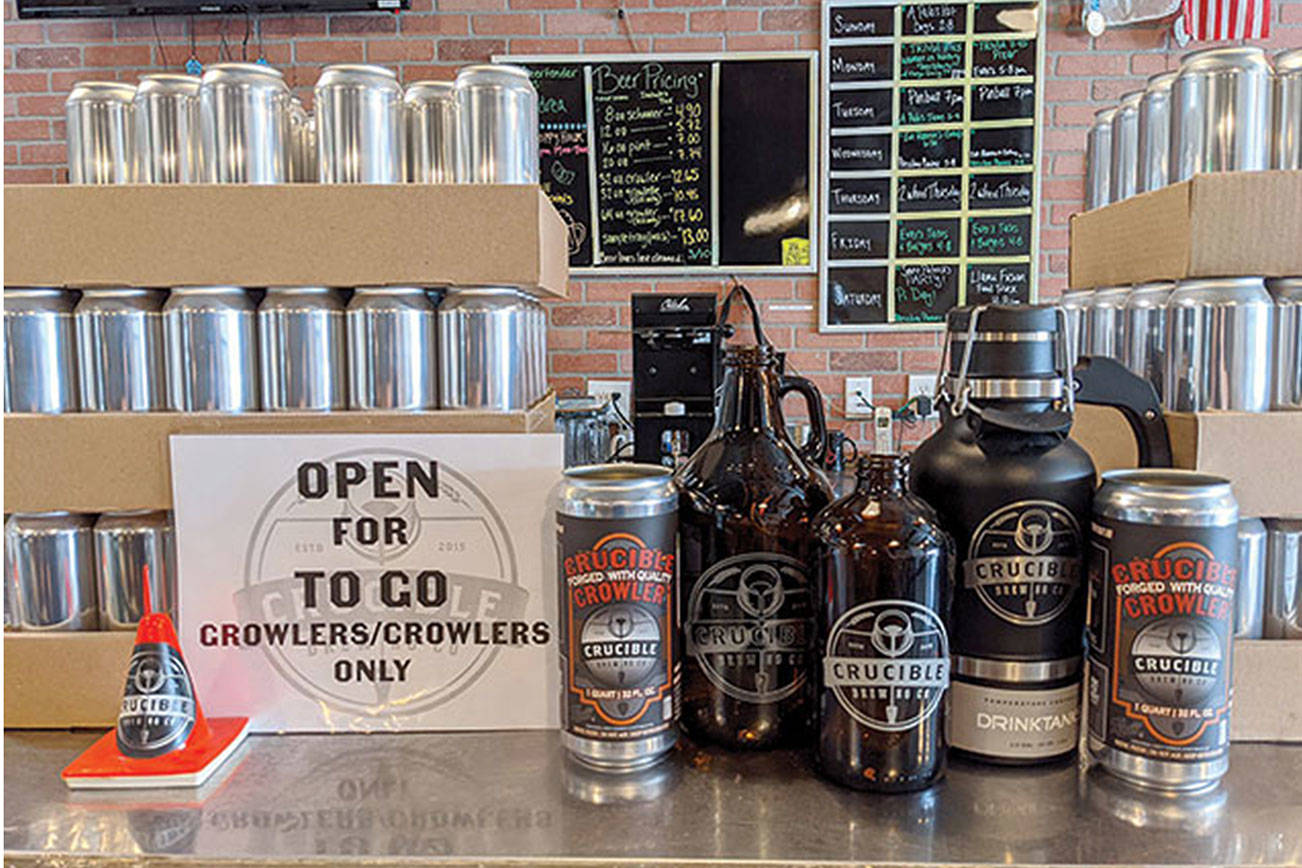 Empty crowlers and growlers from Everett’s Crucible Brewing wait to be filled and delivered to thirsty beer fans in and around Everett. (Crucible Brewing)