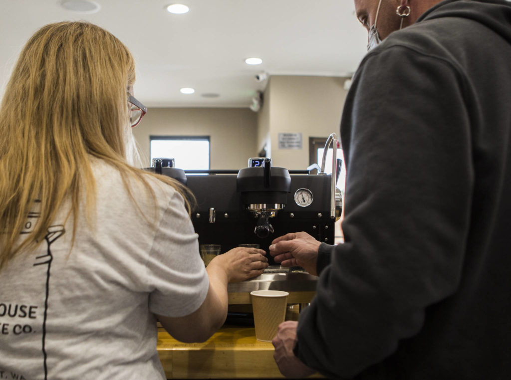Heather and Michael Wallace make cappuccinos Thursday at Milk House Coffee Co. in Everett. (Olivia Vanni / The Herald)
