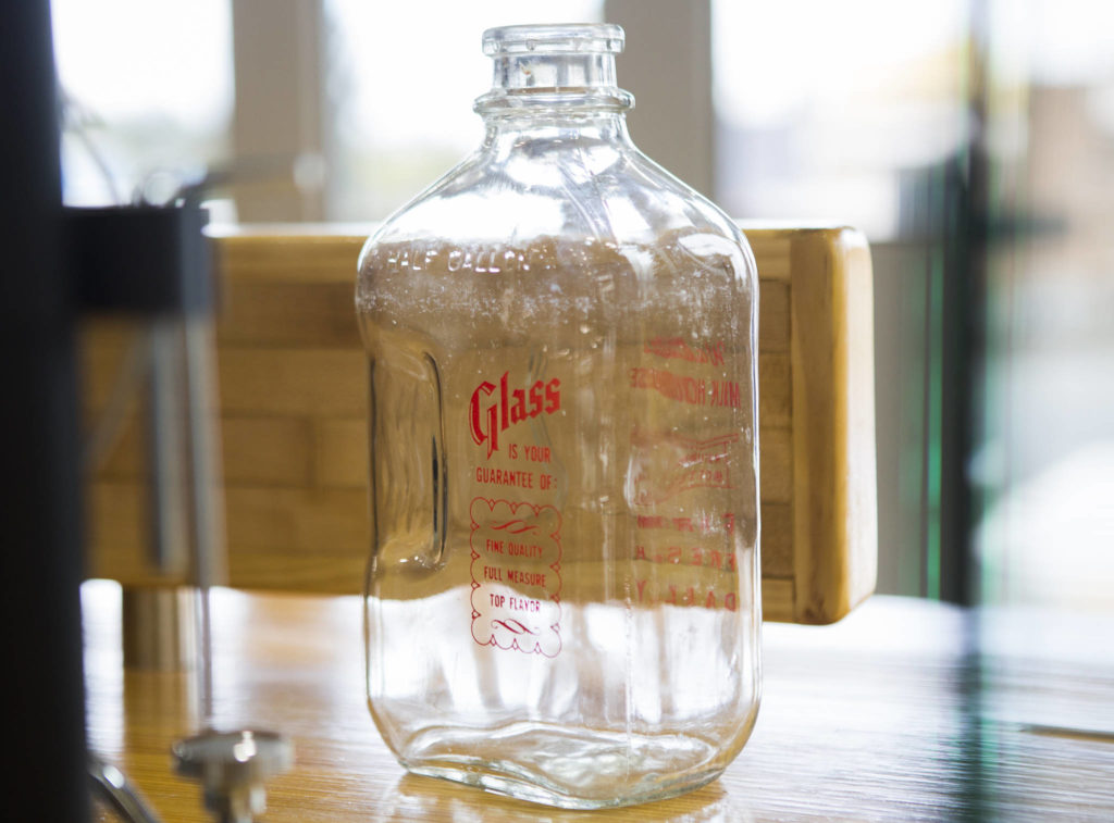 A glass milk jug from Walt’s Milk House is part of the decor at Milk House Coffee Co. in Everett. (Olivia Vanni / The Herald)
