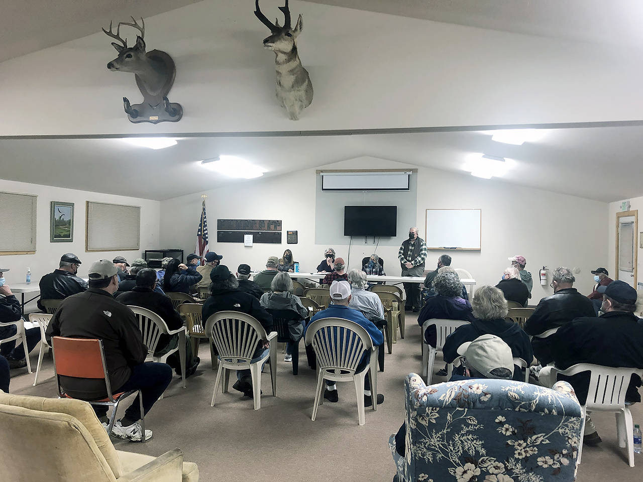 Judy Thorpe (from left), Tracy Weissel, Sarah Westcott and Michael Thorpe listen to the audience during a community meeting at the Central Whidbey Sportsmen’s Association in Coupeville on March 19. About 40 people came to the meeting to discuss their concerns about the Whidbey Homeless Coalition’s proposed emergency overnight shelter on Morris Road in the former Jehovah’s Witness building. (Emily Gilbert / Whidbey News-Times)