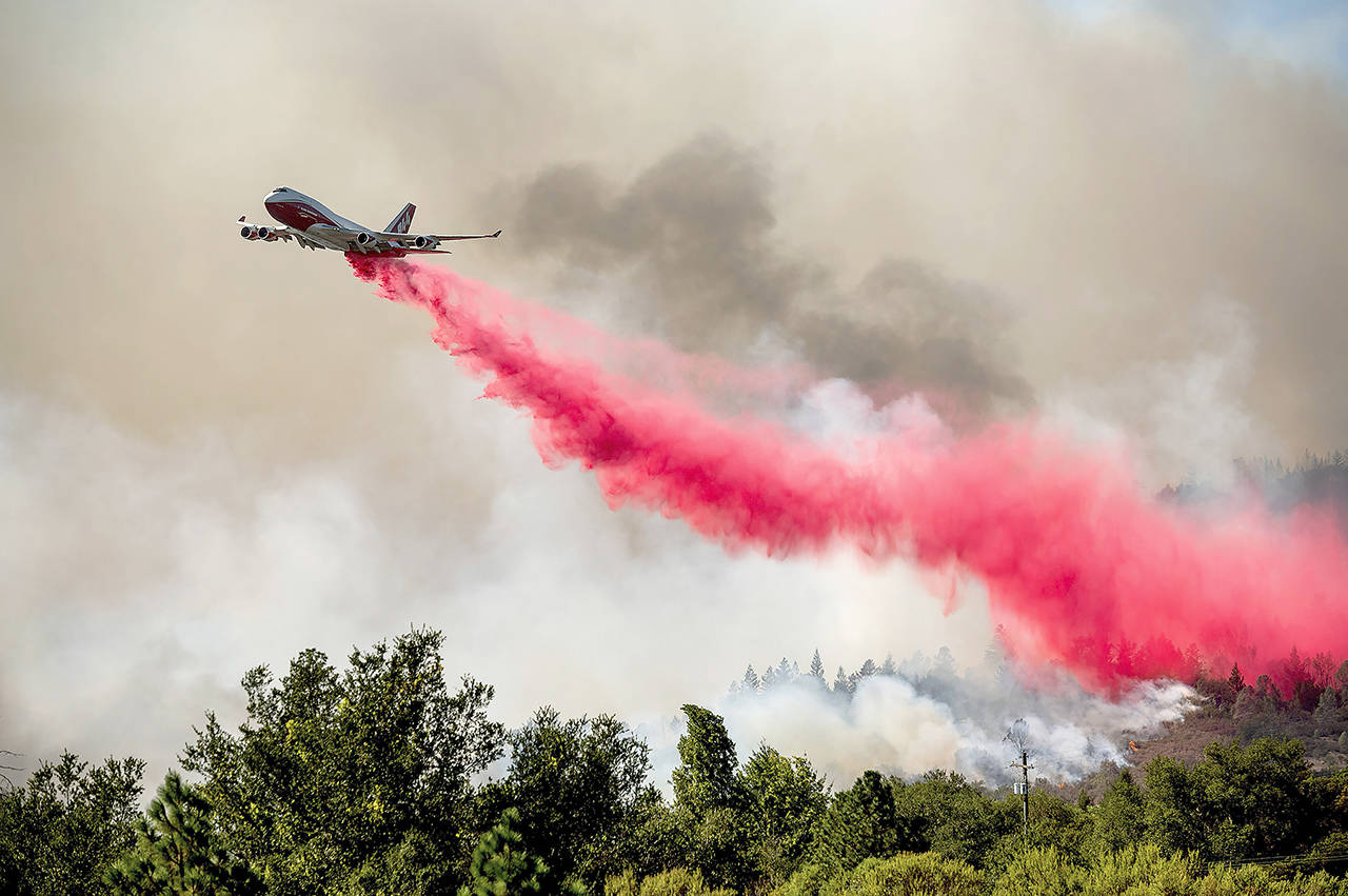 The Global Supertanker drops retardant while battling the Glass Fire in Napa County, California, on Sept. 27, 2020. (AP Photo/Noah Berger, file)