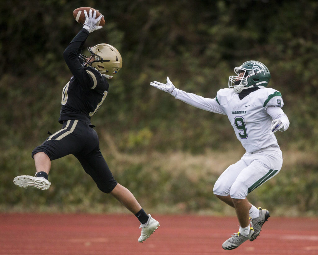 Lynnwood’s John Miguel Hurtado intercepts a pass to Edmonds-Woodway’s Steele Swinton during the game on Friday, March 26, 2021 in Edmonds, Wa. (Olivia Vanni / The Herald)
