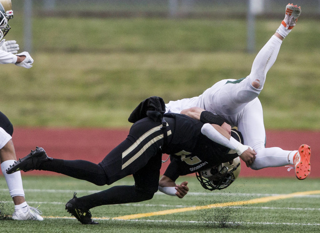 Lynnwood’s Deon Baker hits Edmonds-Woodway’s Charlie Finch during the game on Friday, March 26, 2021 in Edmonds, Wa. (Olivia Vanni / The Herald)
