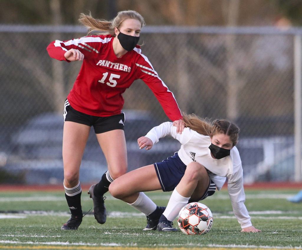 Snohomish’s Alex Prescott and Glacier Peak’s Cheyenne Rodgers try to get to the ball during a girls soccer match at Veterans Memorial Stadium on Monday in Snohomish. (Andy Bronson / The Herald)

