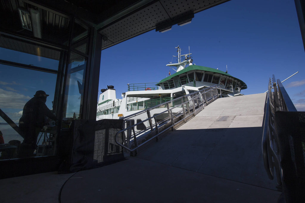 Attendant Robby Davidson raises the new gangplank at the Mukilteo ferry terminal on Monday. (Andy Bronson / The Herald)
