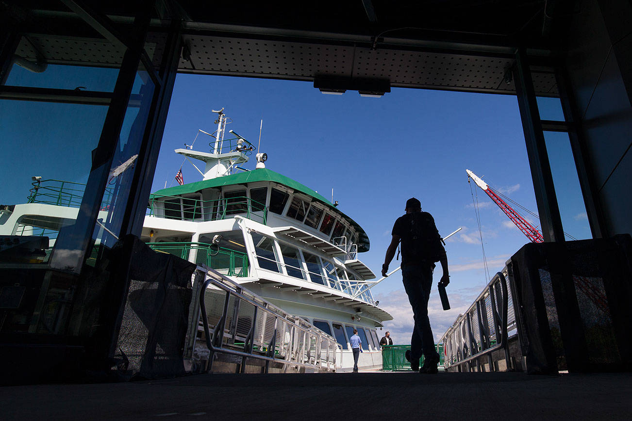 A walk-on passenger uses the plank to board a ferry at the Mukilteo Ferry Terminal on Monday, April 26, 2021 in Mukilteo, Washington. Monday was the first day for the new walk-on service as opposed to the previous method of boarding, using the car ramp ahead of loading cars. (Andy Bronson / The Herald)
