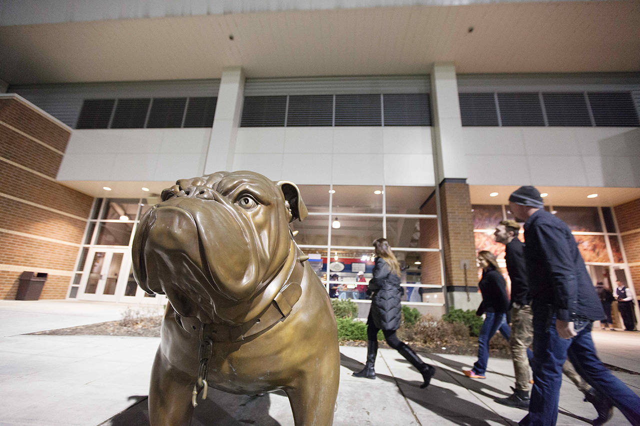 Fans pass a bulldog statue, the team’s mascot, on their way to the entrance at the McCarthey Athletic Center on the Gonzaga University campus in 2014. (AP Photo/Young Kwak, file)