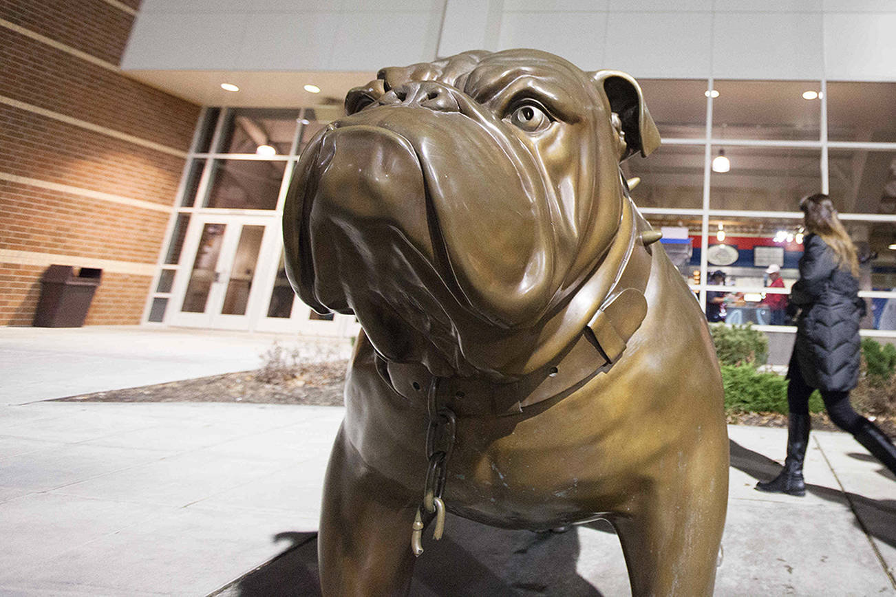 Fans pass a bulldog statue, the team's mascot, on their way to the entrance at the McCarthey Athletic Center on the Gonzaga University campus before an NCAA college basketball game against Texas Southern in Spokane, Wash., Monday, Dec. 15, 2014. (AP Photo/Young Kwak)