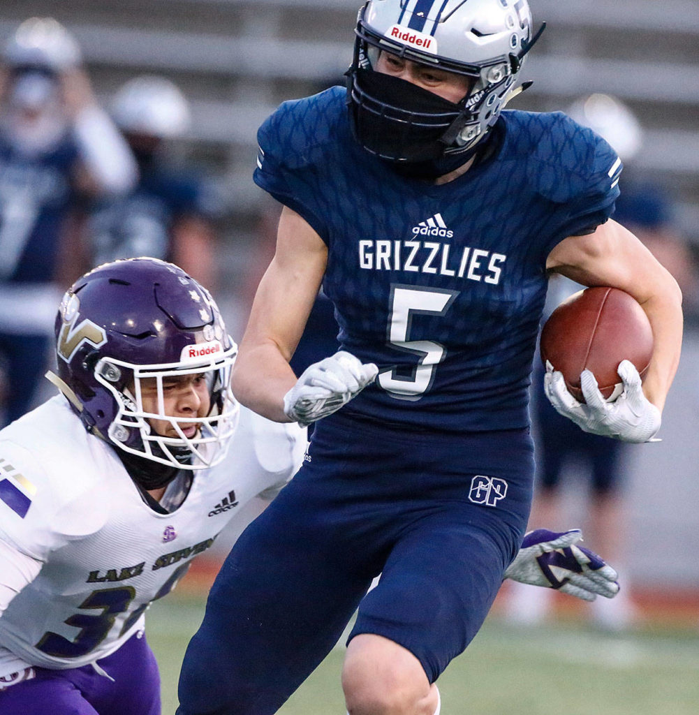 Glacier Peak’s Matthew Torgeson rushes for yardage against Glacier Peak Thursday night at Veterans Memorial Stadium in Snohomish on April 1, 2021. (Kevin Clark / The Herald)
