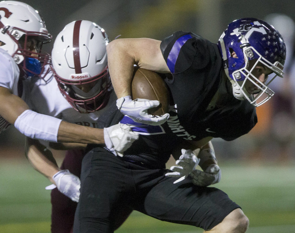 Kamiak’s Wesley Garret runs through multiple tackles during a game against Cascade onApril 1, 2021, in Everett. (Olivia Vanni / The Herald)
