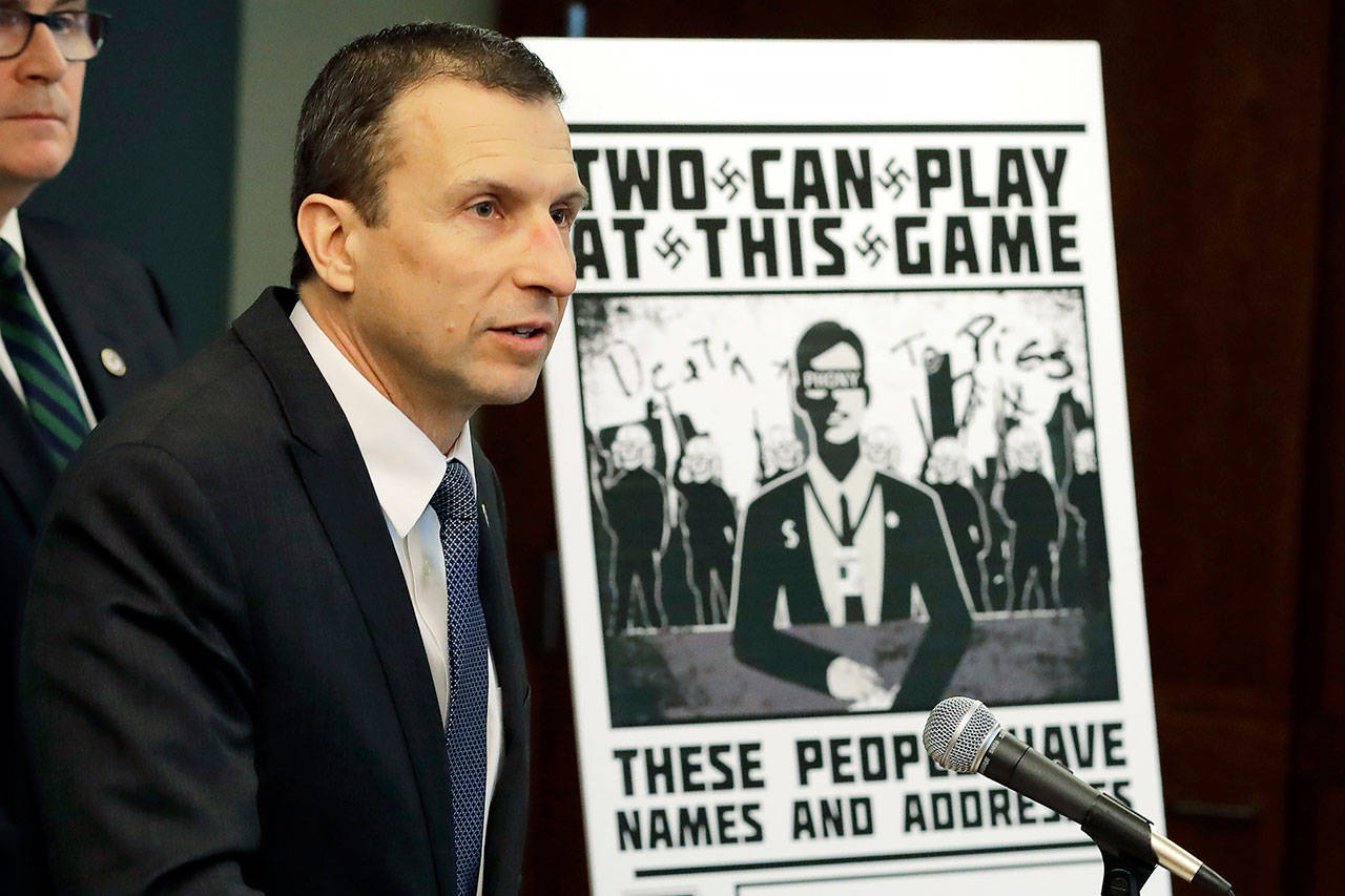 In this Feb. 26, 2020 photo, Raymond Duda, FBI Special Agent in Charge in Seattle, speaks as he stands next to a poster that was mailed earlier in the year to the home of Chris Ingalls, an investigative reporter with KING-TV during a news conference in Seattle. (AP Photo/Ted S. Warren, File)