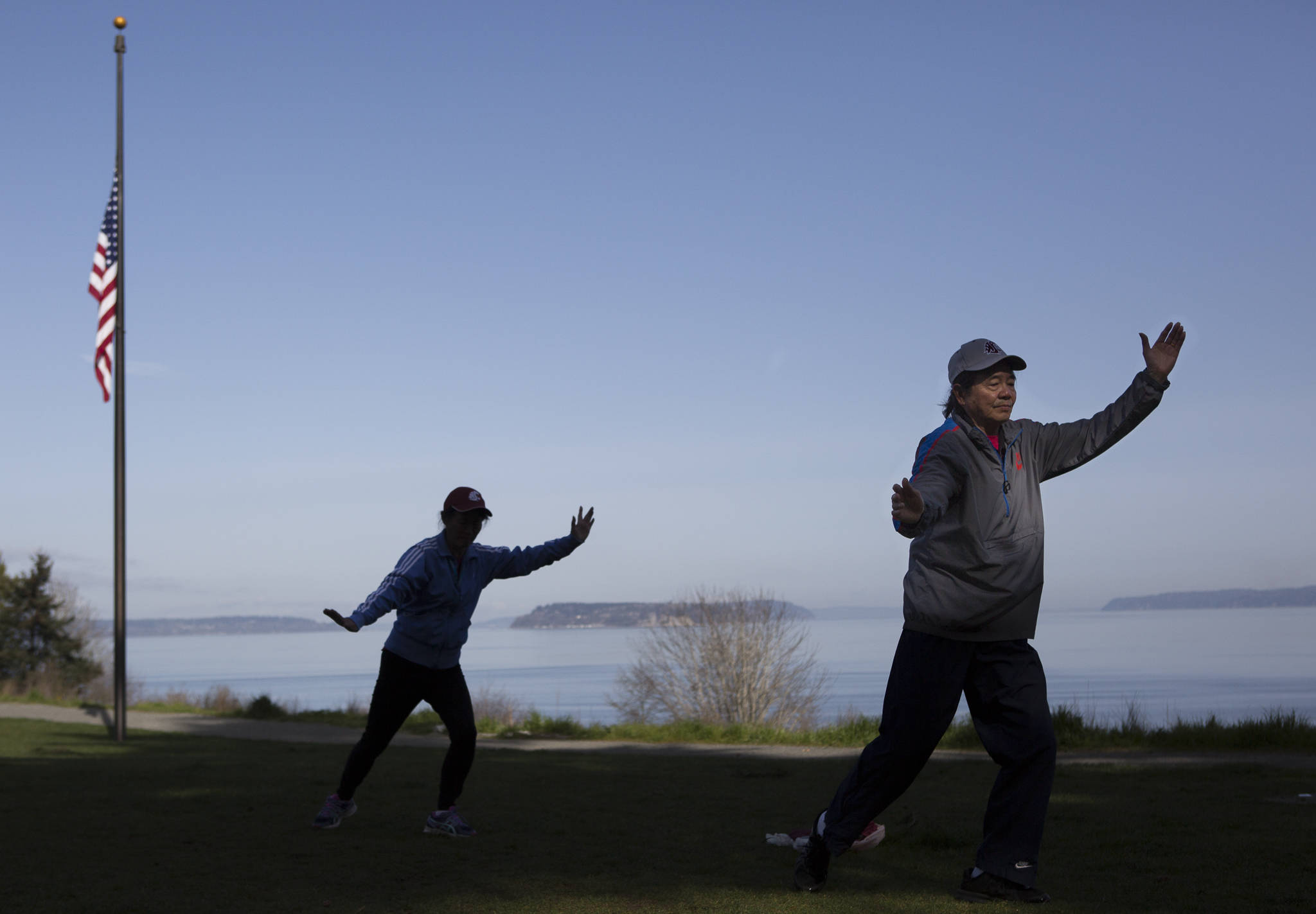 Dongyue Zhuang and Hong Li go through a section of tai chi movements at Harborview Park on Tuesday in Everett. (Olivia Vanni / The Herald)