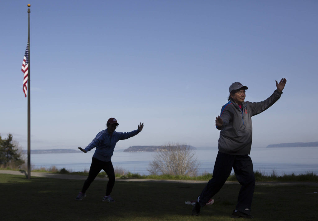 Dongyue Zhuang and Hong Li go through a section of tai chi movements at Harborview Park on Tuesday in Everett. (Olivia Vanni / The Herald)
