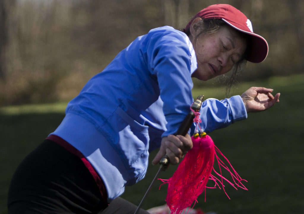 Dongyue Zhuang does advanced tai chi sword movements at Harborview Park on Tuesday in Everett. (Olivia Vanni / The Herald)
