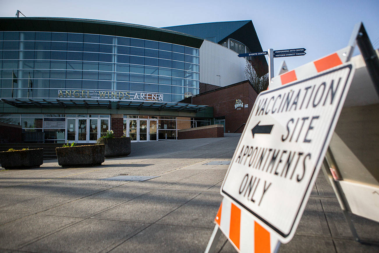 Stenczie Morgan with Maxim Healthcare Services sets up one of the four vaccination stations at the Angel of the Winds Area vaccination site on Tuesday, April 6, 2021 in Everett, Wa. (Olivia Vanni / The Herald)