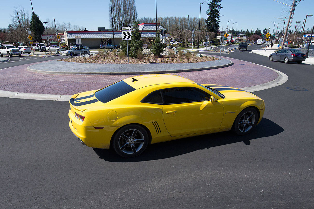 Drivers go around a roundabout at 204th Street NE and 77th Avenue NE on Monday, April 12, 2021 in Arlington, Washington.  (Andy Bronson / The Herald)