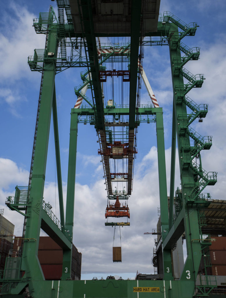 Cargo is offloaded from Westwood Columbia, a 655-foot ship carrying aerospace components, consumer goods and industrial equipment, at South Terminal of the Port of Everett on Thursday. (Olivia Vanni / The Herald) 
