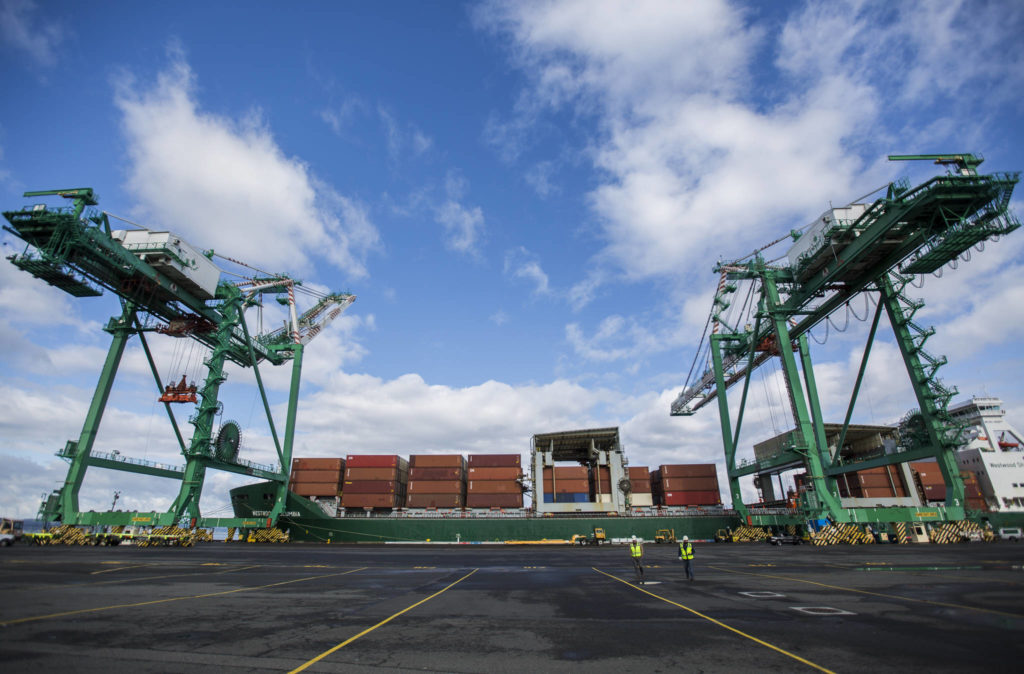 One of two cranes works to offload cargo at the South Terminal of the Port of Everett on Thursday. (Olivia Vanni / The Herald)
