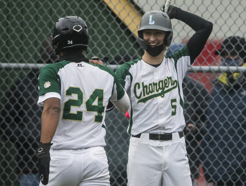 Marysville Getchell’s Keegan Agen (5) fist bumps Malakhi Knight after scoring during a game against Marysville Pilchuck on April 7, 2021, in Marysville. (Olivia Vanni / The Herald)
