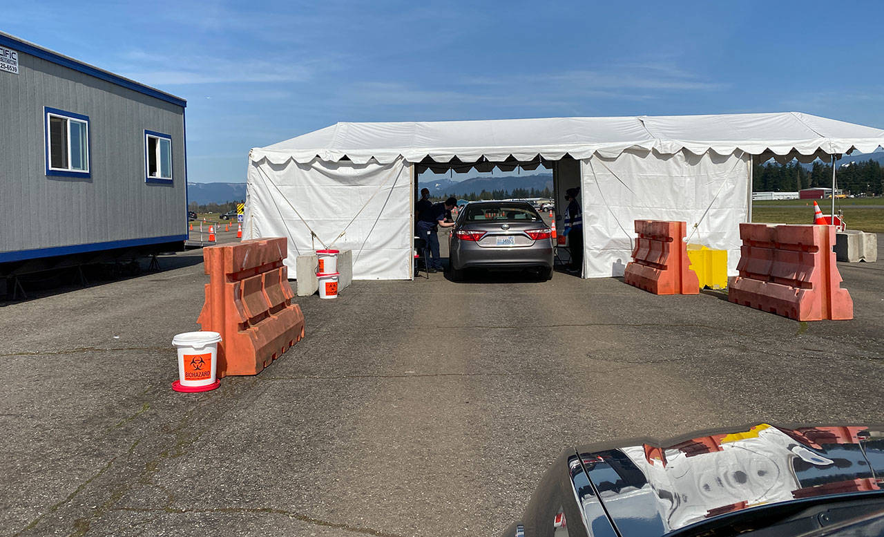 More than 155,000 Snohomish County residents have been fully vaccinated, while another 100,000 are awaiting their second dose, according to state data. Here, people get vaccinated at the Arlington Airport site on March 31. (Sue Misao / The Herald)