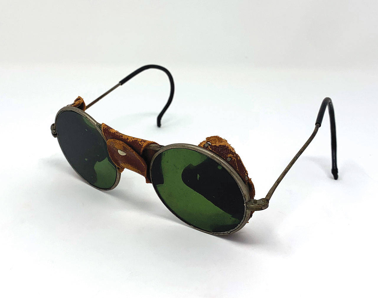 This is a very early pair of glasses with tinted lenses not used as sunglasses. (Cowles Syndicate Inc.)
