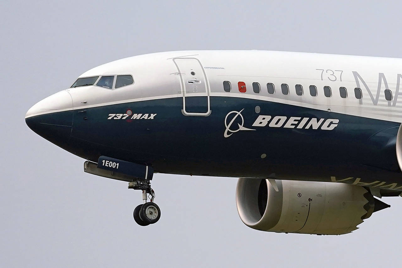 In this September 2020 photo, a Boeing 737 Max jet, piloted by Federal Aviation Administration (FAA) chief Steve Dickson, prepares to land at Boeing Field following a test flight in Seattle. (AP Photo/Elaine Thompson, File)