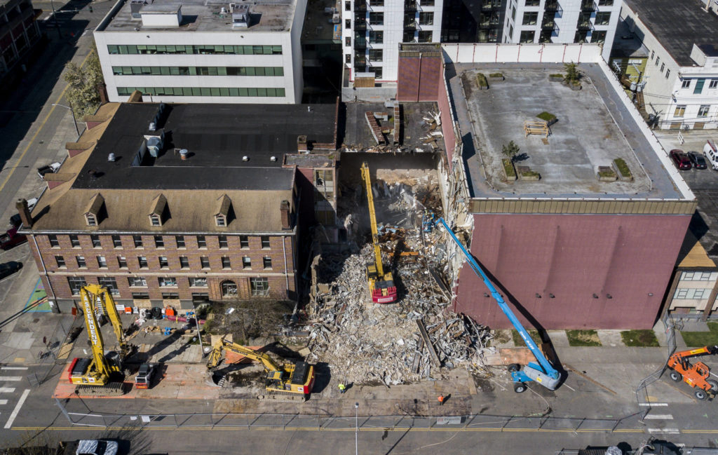 Crews work on the demolition of the former YMCA annex in downtown Everett on Tuesday. (Olivia Vanni / The Herald)
