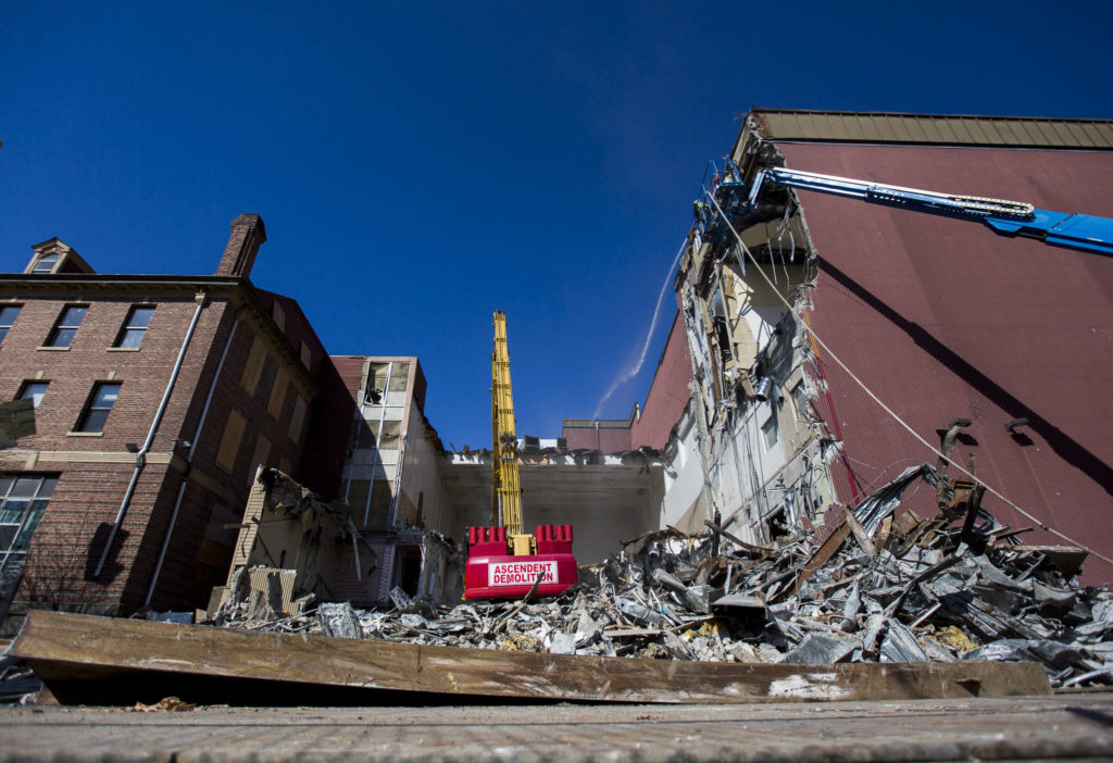 Crews work on the demolition of the YMCA in downtown Everett on Tuesday. (Olivia Vanni / The Herald)
