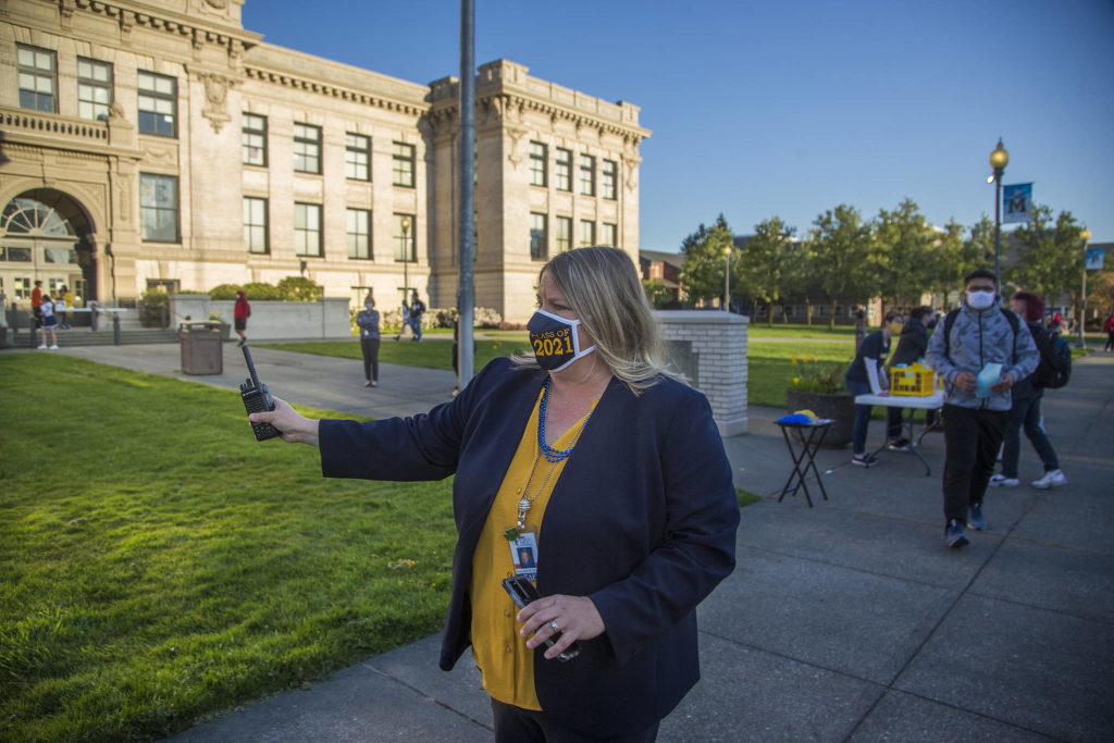 First-year principal Amanda Overly directs students before the start of the first day of in-person school at Everett High on Monday. (Andy Bronson / The Herald)

