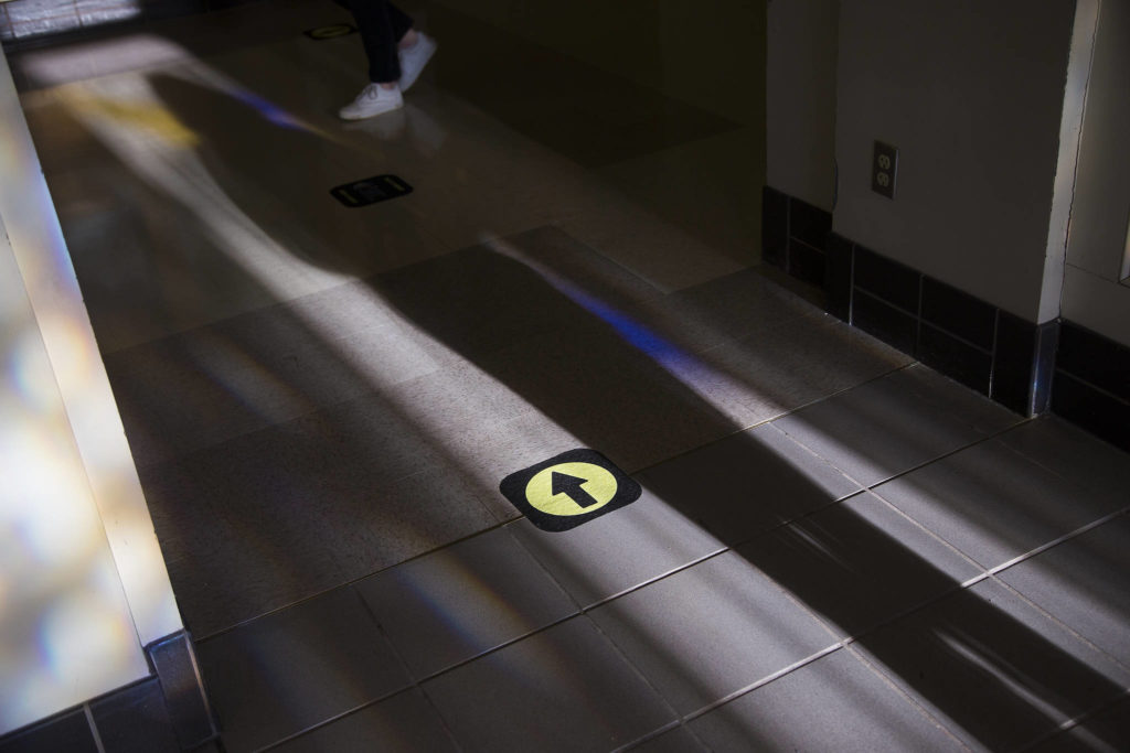 Arrows direct students through the hallways on Monday at Everett High as students attend classes in person for the first time this year. (Andy Bronson / The Herald)
