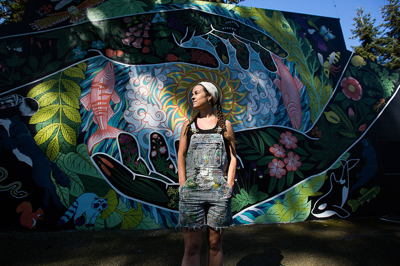 Local artist Gabrielle Abbott with her mural "Grateful Steward" at South Lynnwood Park on Wednesday, April 21, 2021 in Lynnwood, Wash. (Olivia Vanni / The Herald)