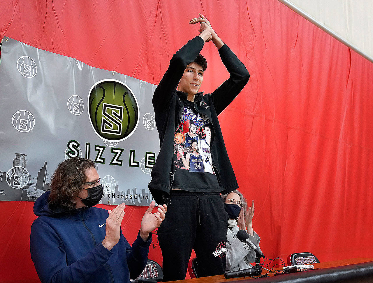 Minnehaha Academy’s Chet Holmgren, the No. 1 NCAA college basketball recruit in the country, gestures during a press conference Monday at which he announced he will be attending Gonzaga University to play basketball. Holmgren Chet is flanked by his father, David Holmgren, and mother, Sarah Harris. (Associated Press)