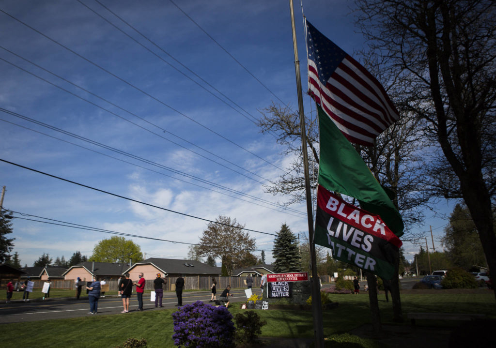 A Black Lives Matter flag blows in the wind outside of the Marysville School District Service Center on Wednesday. (Olivia Vanni / The Herald)
