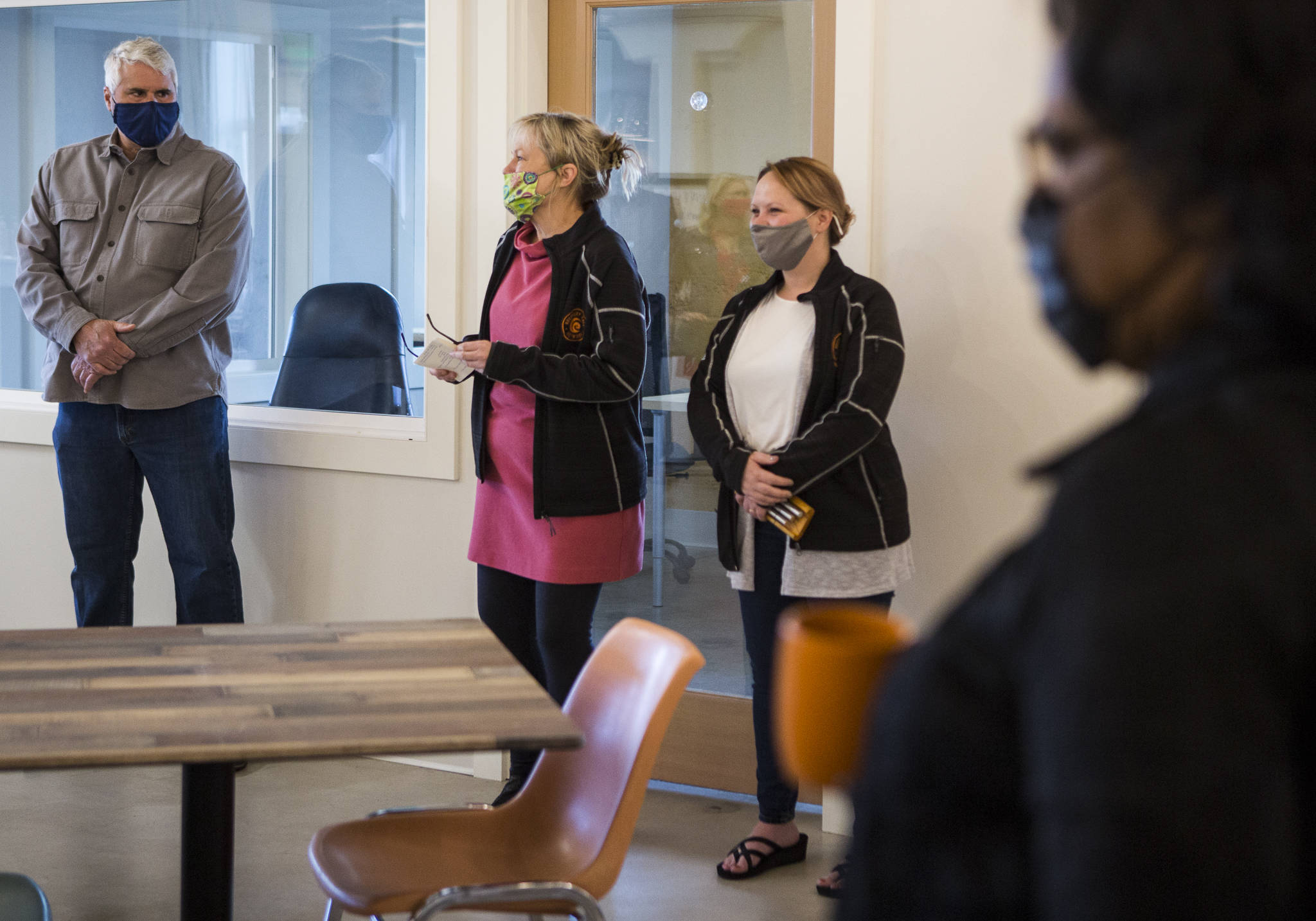 Wendy Grove (center), founder and executive director of the Recovery Cafe in Everett, speaks during the grand opening on Wednesday in Everett. (Olivia Vanni / The Herald)