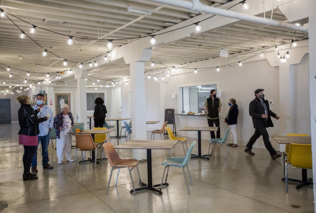People explore the new Everett Recovery Cafe during the grand opening on Wednesday. (Olivia Vanni / The Herald)
