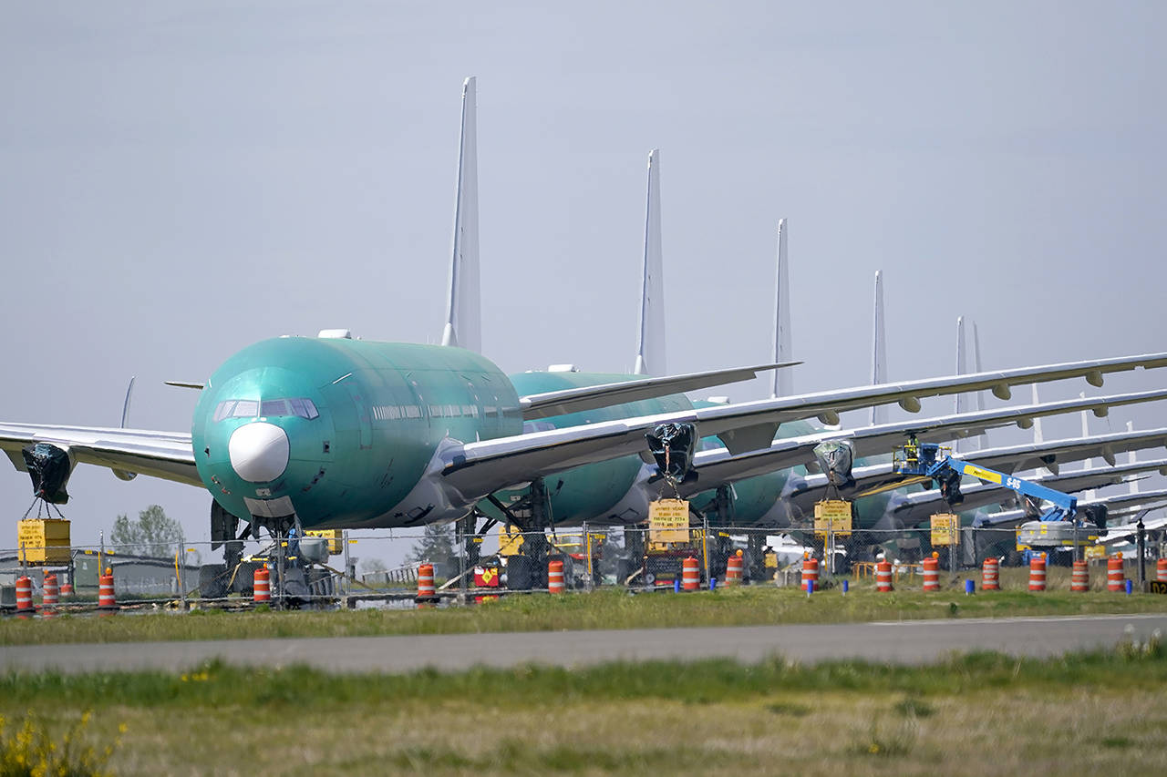 A line of Boeing 777X jets are parked nose to tail on an unused runway at Paine Field, near Boeing’s massive production facility, on April 23 in Everett. (AP Photo/Elaine Thompson)