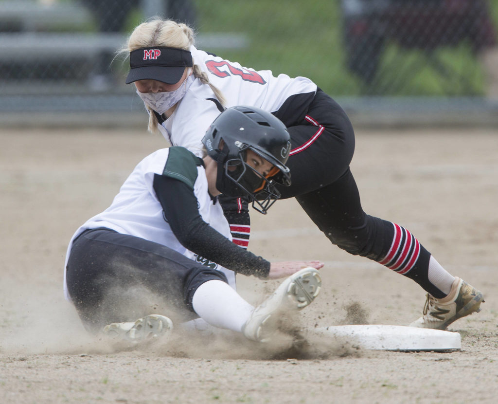 Jackson’s Avery Hare (bottom) slides safely into second base during a game against Marysville Pilchuck on April 28, 2021, in Mill Creek. Jackson beat Marysville Pilchuck 6-0. (Andy Bronson / The Herald)
