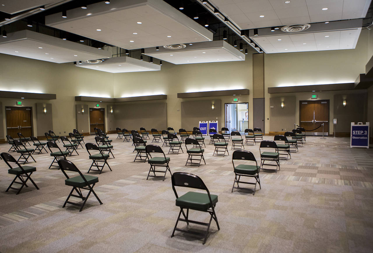 A waiting area for people after receiving their vaccinations at Angel of the Winds Arena seen April 6 in Everett. (Olivia Vanni / Herald file)