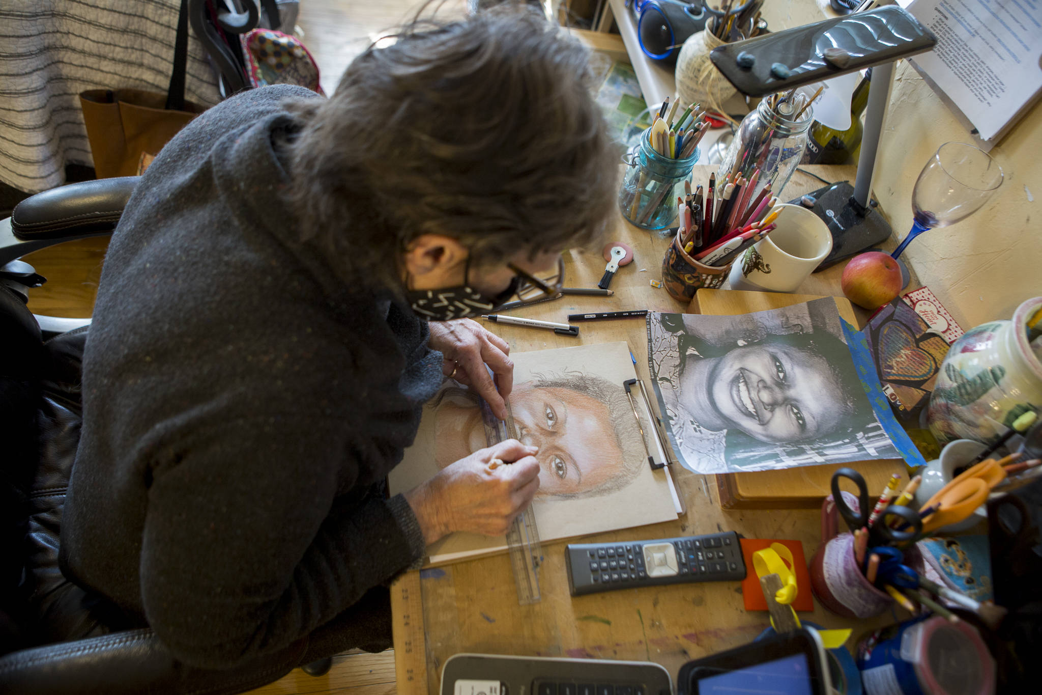 Snohomish artist Cathy Tanasse works on facial proportions on one of her “Memory Project” portraits, March 19 in Snohomish. (Olivia Vanni / The Herald)