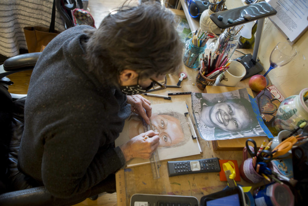 Snohomish artist Cathy Tanasse works on facial proportions on one of her “Memory Project” portraits, March 19 in Snohomish. (Olivia Vanni / The Herald)
