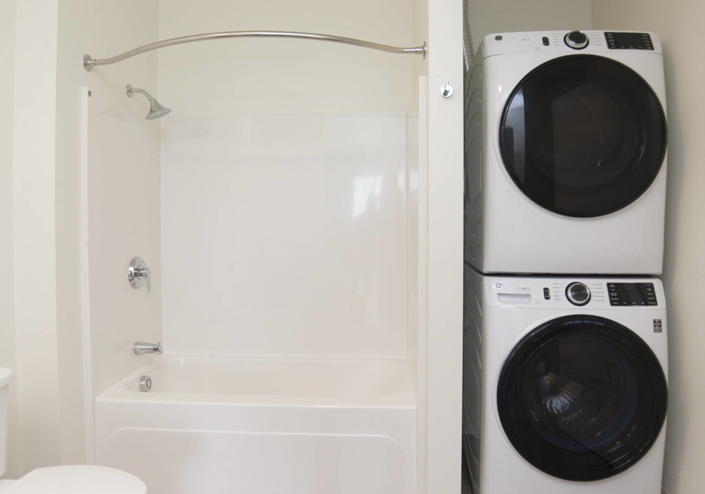 A stacked washer and dryer set is seen in one of 135 apartments available in the Waterfront Place Apartments in Everett. (Andy Bronson / The Herald)
