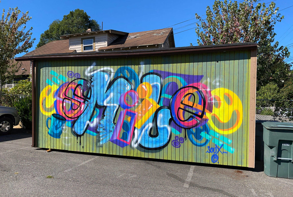 Graffiti adds a pop of color near Ed’s Transmission on Everett Avenue. (Sue Misao / The Herald)
