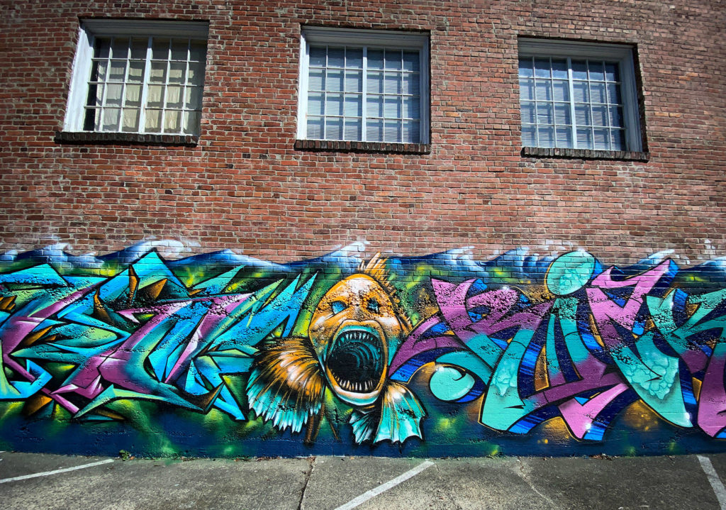 A toothy fish is painted near the Rubatino Refuse parking lot on Hoyt Avenue. (Sue Misao / The Herald)

