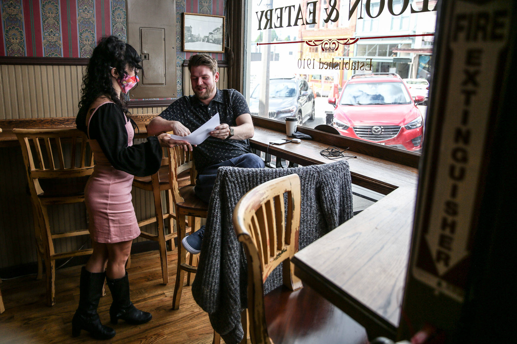 Breanna Schalamon takes Joel Childs’ orders Tuesday afternoon at Oxford Saloon in Snohomish. (Kevin Clark / The Herald)