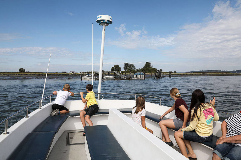 The Jetty Island passenger ferry, seen here Aug. 31, 2019 approaching the sand bar, is set to resume July 5 after the city suspended it last year because of public health guidelines and budget woes related to the COVID-19 pandemic. (Lizz Giordano / Herald file)
