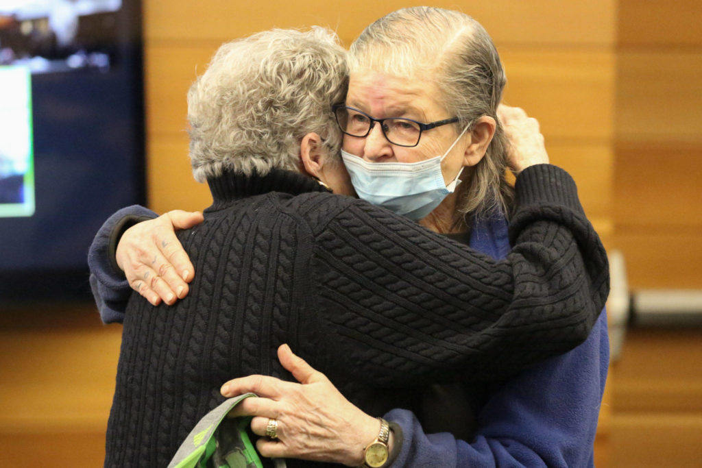 Kathy Parks, (left) widow of Gary Parks hugs Terri Johnson, mother of Elmer Nash, after Nash was sentenced to 10 years in prison Thursday afternoon in Snohomish County Superior Court on May 13, 2021. (Kevin Clark / The Herald)
