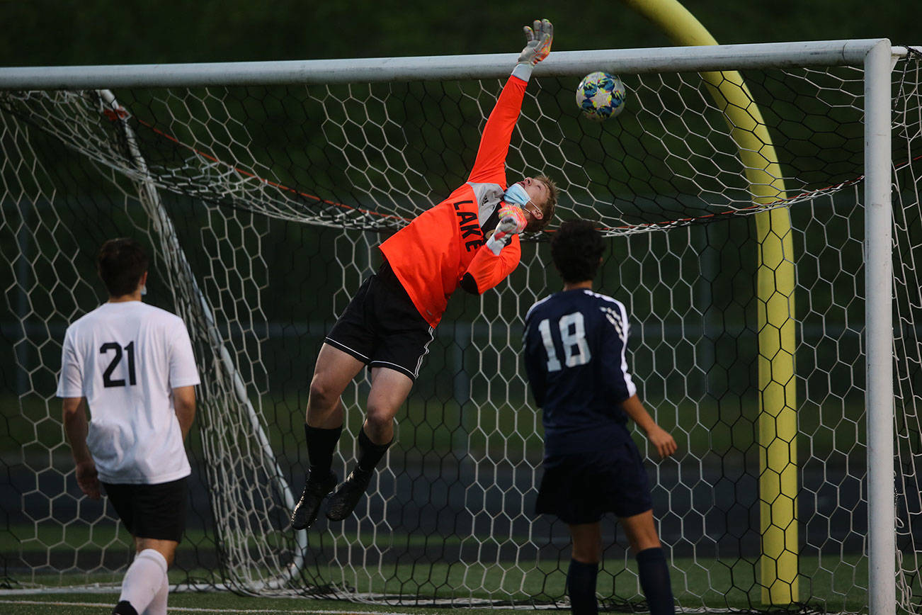 Lake Stevens' Tanner Jordan leaps but misses the ball for an Arlington goal as Arlington beat Lakes Stevens 2-1 in a boys soccer march on Monday, May 3, 2021 in Arlington, Washington.  (Andy Bronson / The Herald)