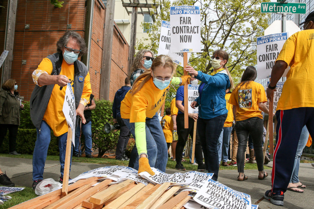 Picketers prepare to march Wednesday afternoon across from Providence Medical Center in Everett. (Kevin Clark / The Herald)
