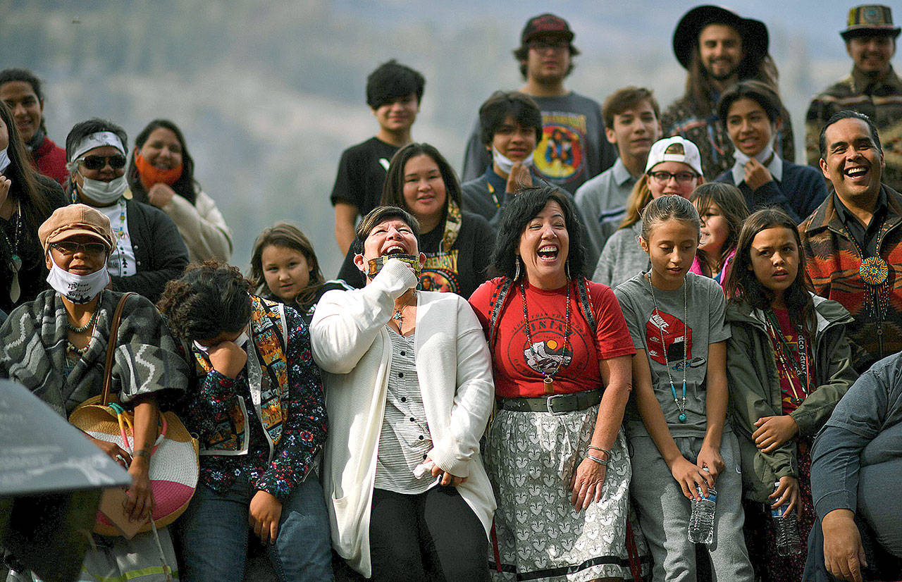 Linda Desautel, center in white, looks skyward and cheers with friends and Colville Confederated Tribe members as they rally in support of her husband Rick Desautel, whose case in the Canadian Supreme court arguing for the Sinixt peoples’ right to hunt traditional lands in Canada was first heard. (Tyler Tjomsland/The Spokesman-Review via AP)