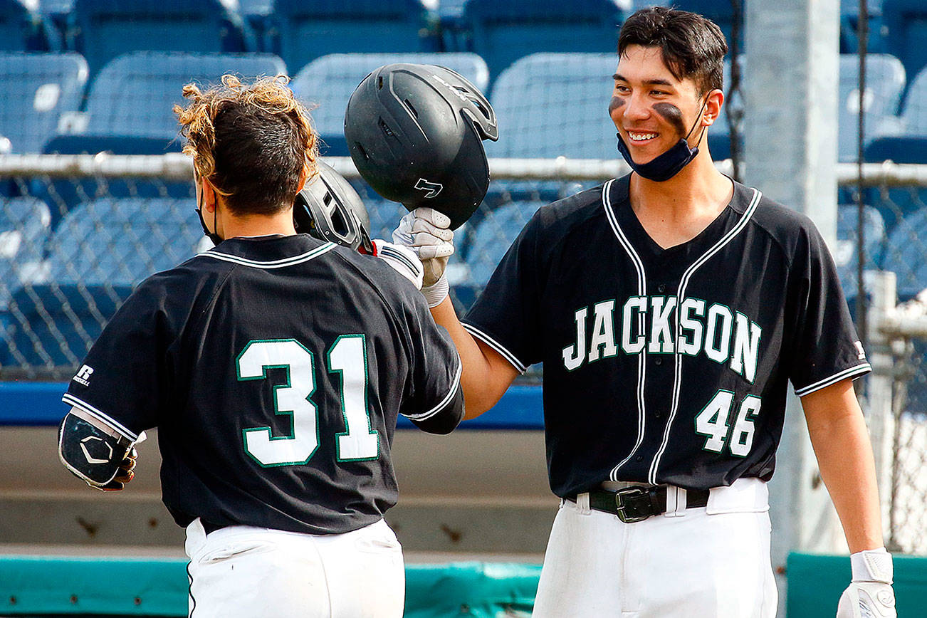 Jackson's Ryan Contreras is welcomed by teammate Dominic Hellman after Contreras' home run Friday afternoon at Funko Field at Memorial Stadium in Everett on April 23, 2021.  (Kevin Clark / The Herald)